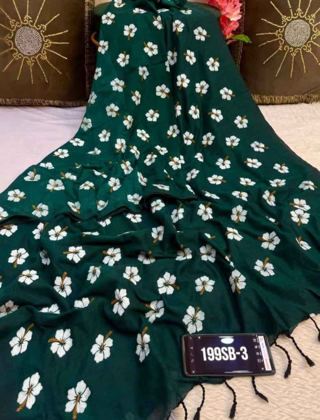 Green fabric with white floral pattern on a textured surface