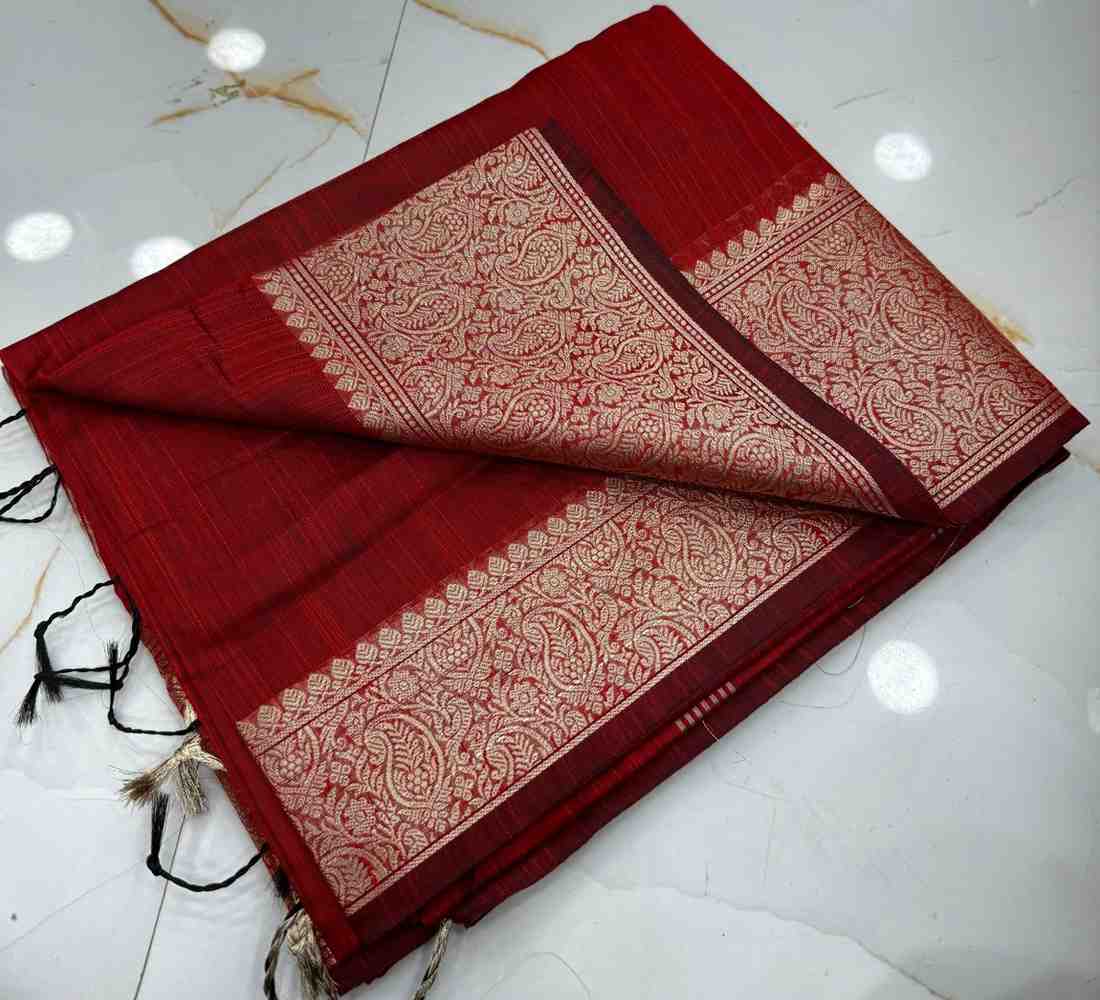 Red saree with gold patterns on a white floor