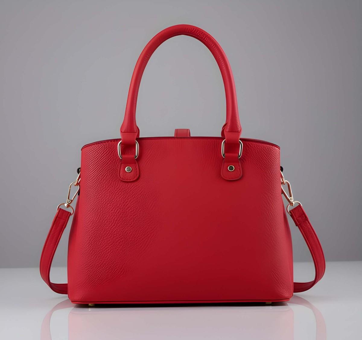 Red handbag with gold accents on a gray background