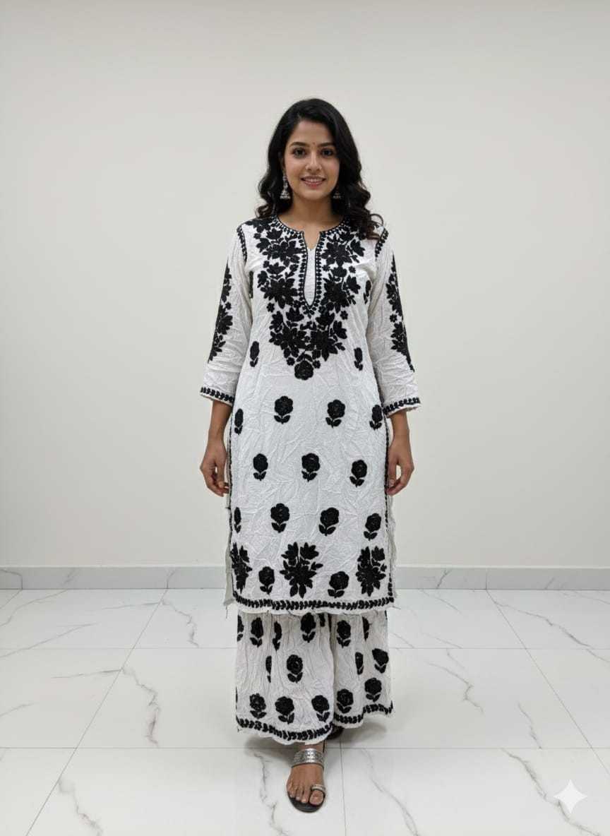 Woman wearing a black and white patterned outfit on a white background