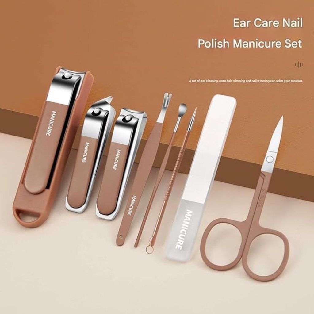 Manicure and ear care set with tools on a beige surface and brown background