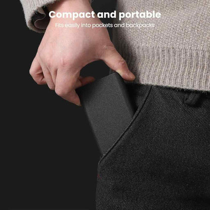 Person inserting a compact black device into their pocket with text 'Compact and portable, fits easily into pockets and backpacks'.