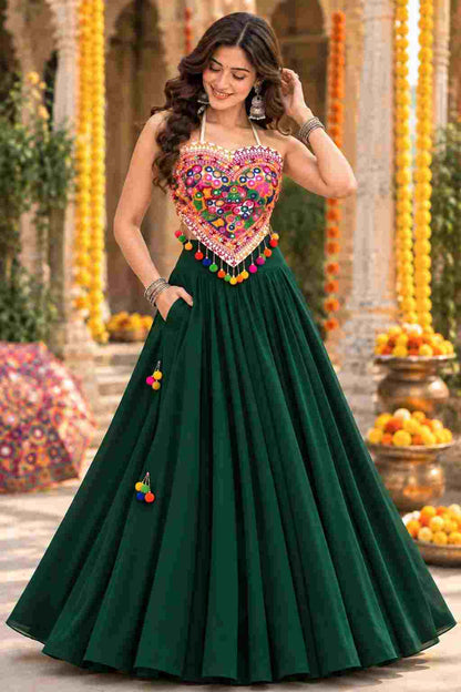 Front view of green georgette Navratri lehenga choli with Katchi mirror work.