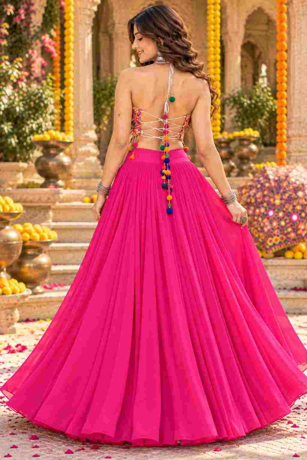 Backless view of pink georgette lehenga with colourful tassel string closure.