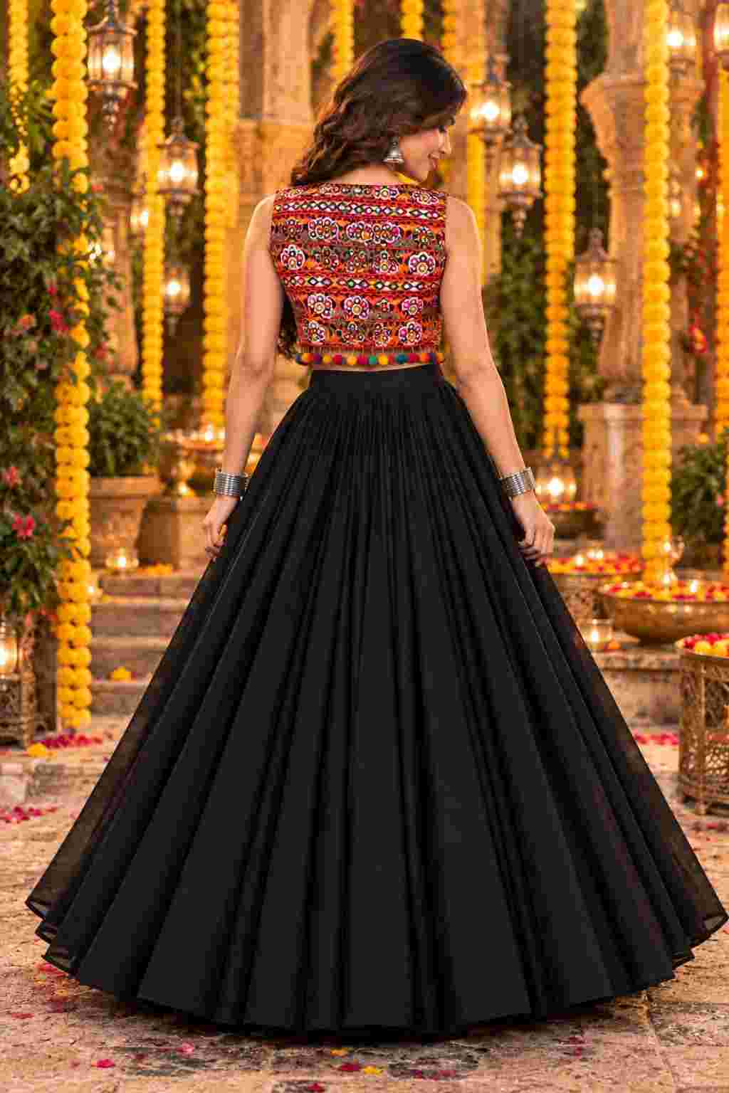 Back view of a black lehenga highlighting a Gujarati embroidered jacket.