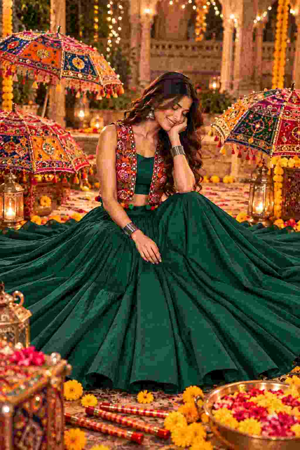Sitting in a dark green lehenga with a Katchi mirror work jacket.   