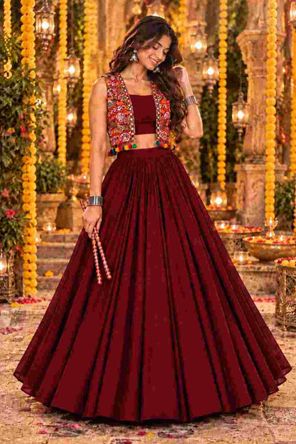 Front view of a maroon lehenga set with an embroidered jacket.