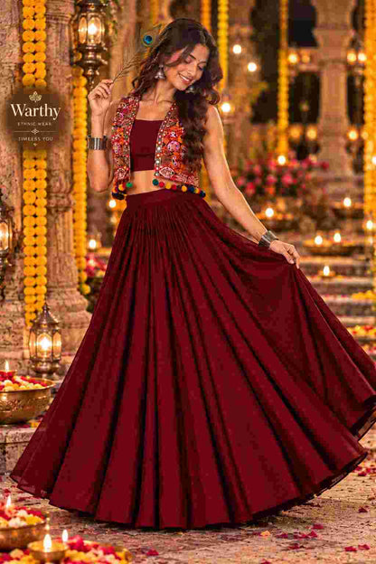 Side pose of a model in a maroon lehenga choli.