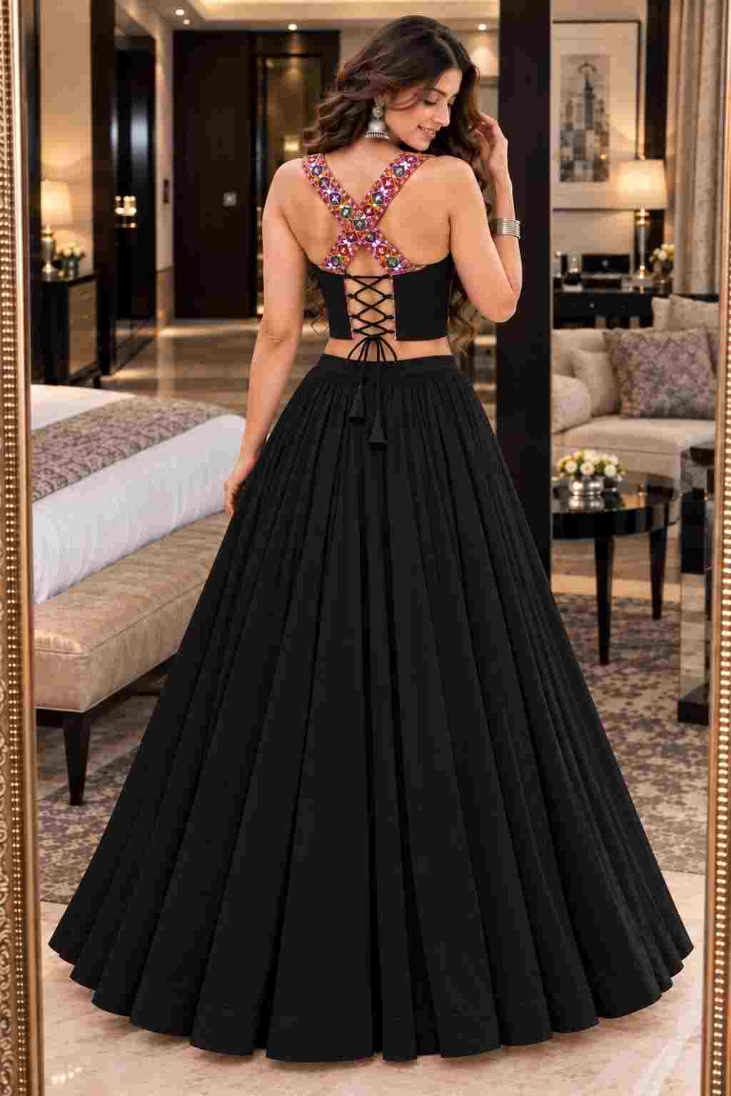 Back view of a black lehenga choli featuring cross-back straps and tie-up laces.   