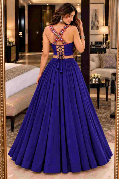 Back view of a blue lehenga choli featuring cross-back straps and tie-up laces.