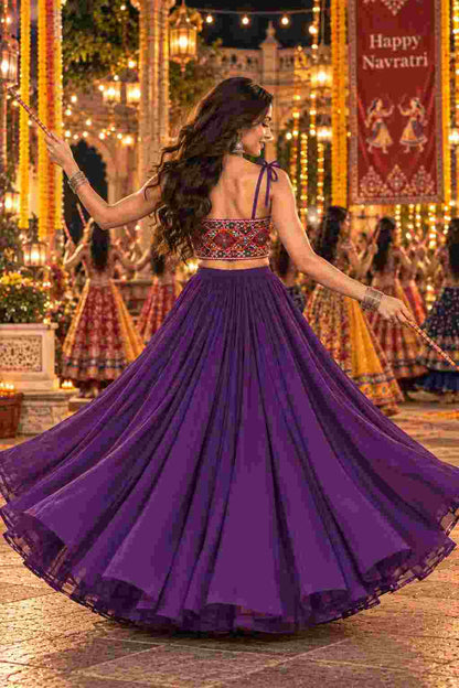 Flared purple lehenga showing tie-up shoulder straps. 
