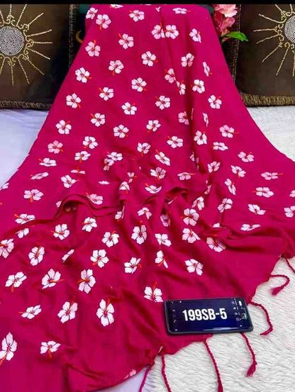 Red fabric with white floral patterns on a textured surface
