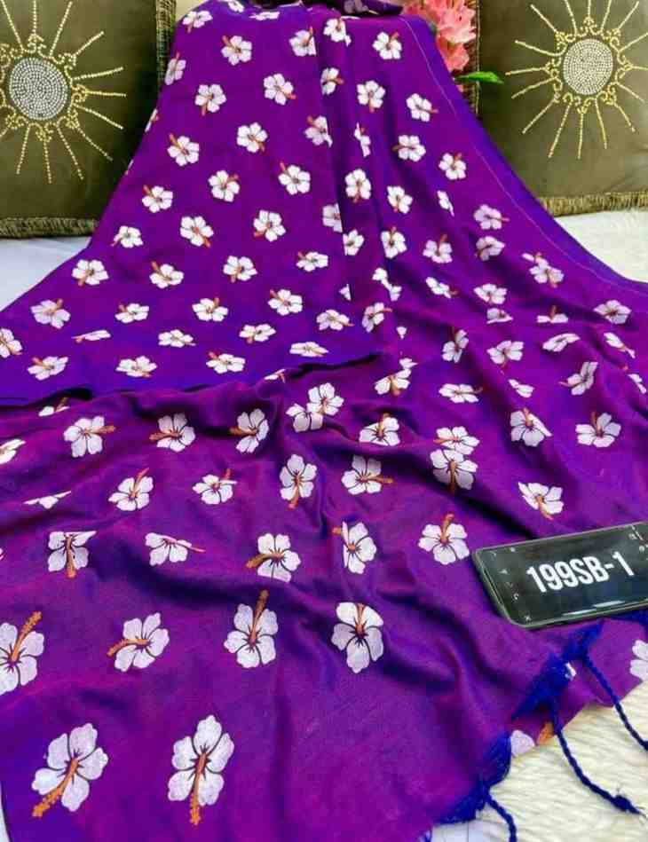 Purple fabric with white floral patterns on a green cushioned surface.