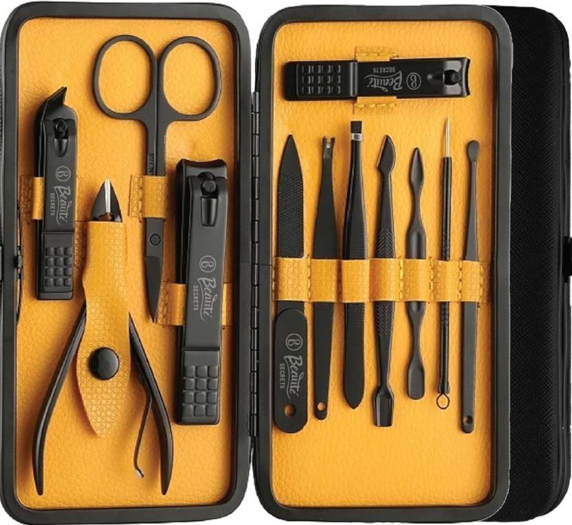Manicure set with tools including scissors and nail clippers in a black case on a yellow background.
