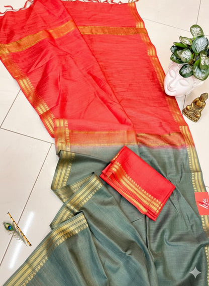 Red and green saree with gold border on a tiled floor.