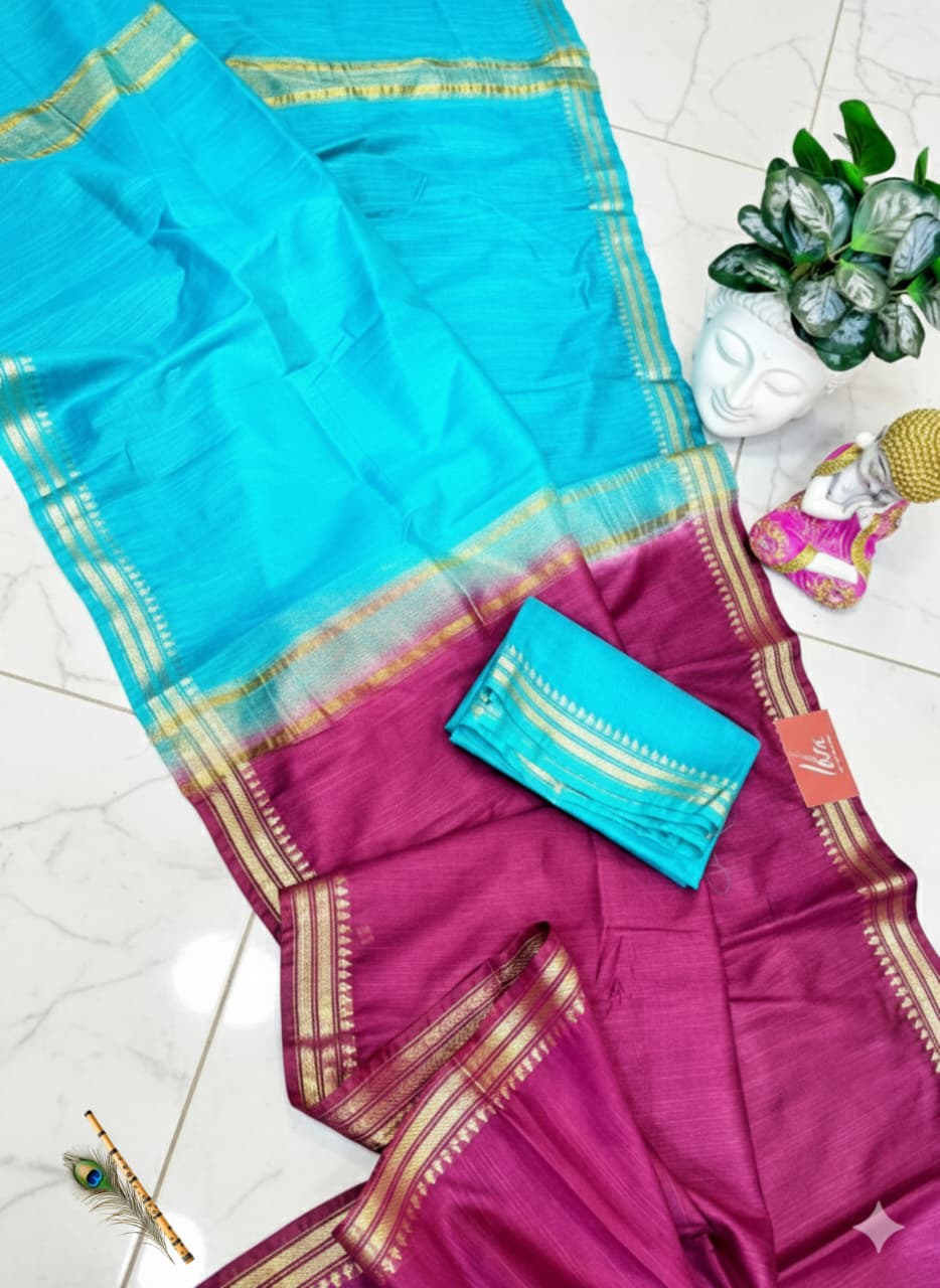 Saree with a blue and pink design on a white floor.