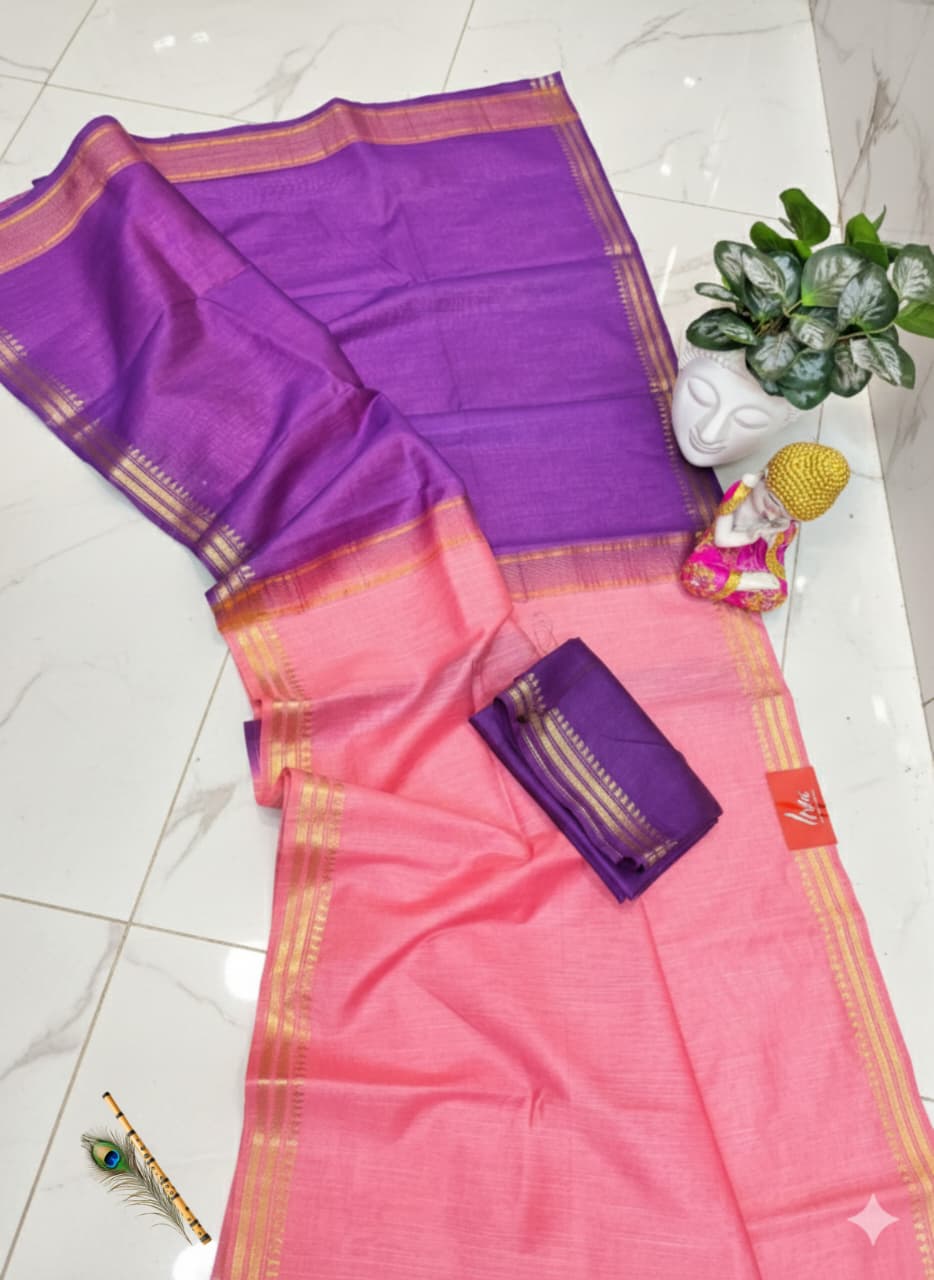 Pink and purple saree with a small pouch on a white floor.