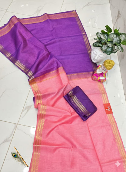 Pink and purple saree with a small pouch on a white floor.