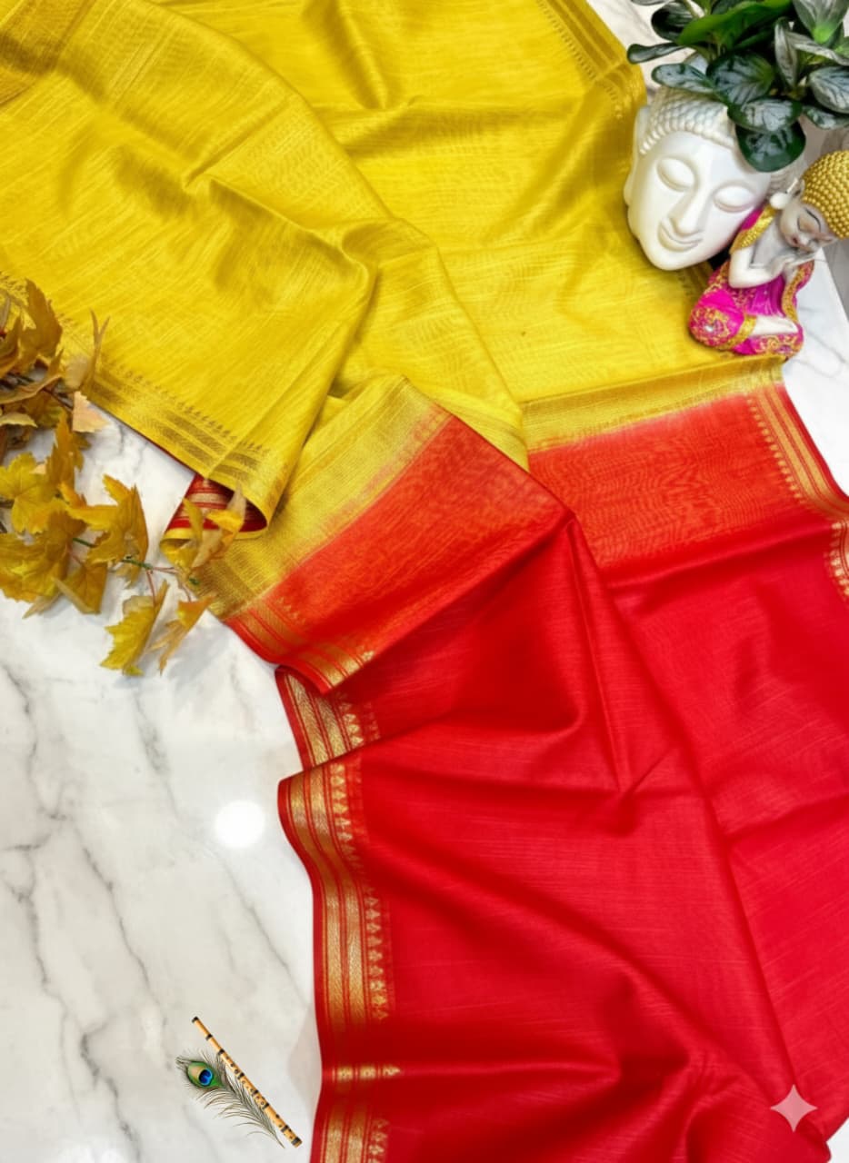 Yellow and red saree with decorative elements on a marble surface