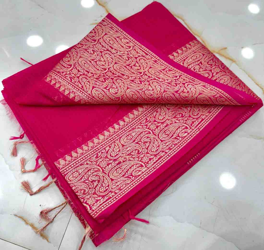 Pink fabric with intricate white patterns on a white background