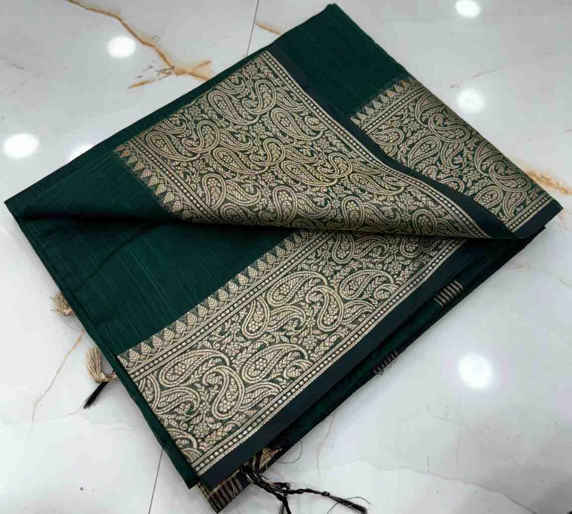 Dark green saree with gold patterns on a white marble surface
