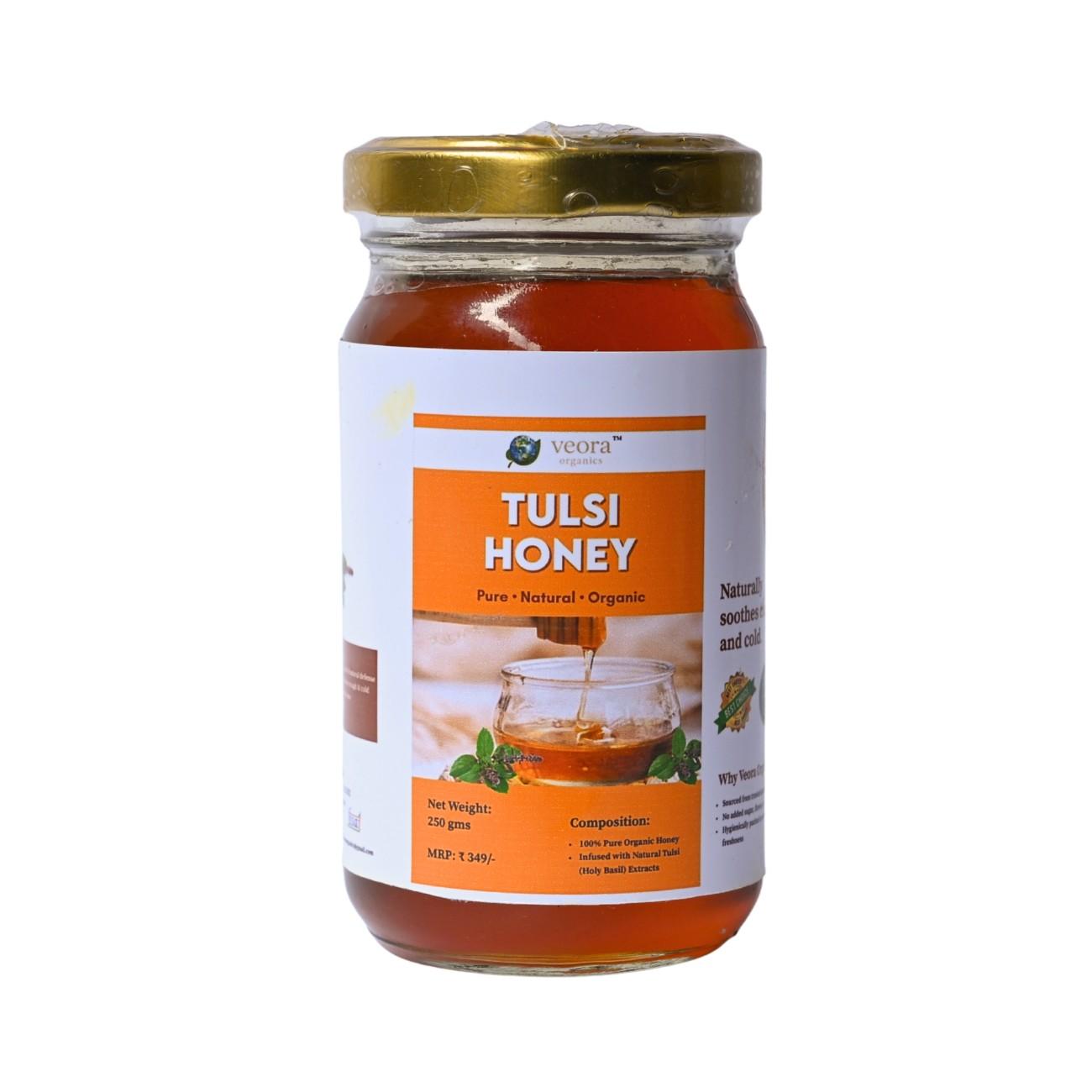 Jar of Tulsi honey with a gold lid on a white background
