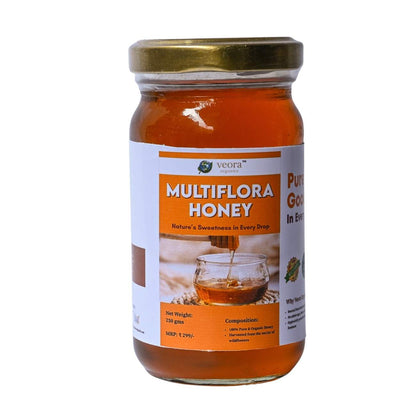 Jar of Multiflora Honey with a gold lid on a white background