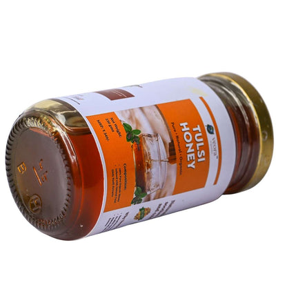 Jar of Tulsi Honey with a visible label on a white background