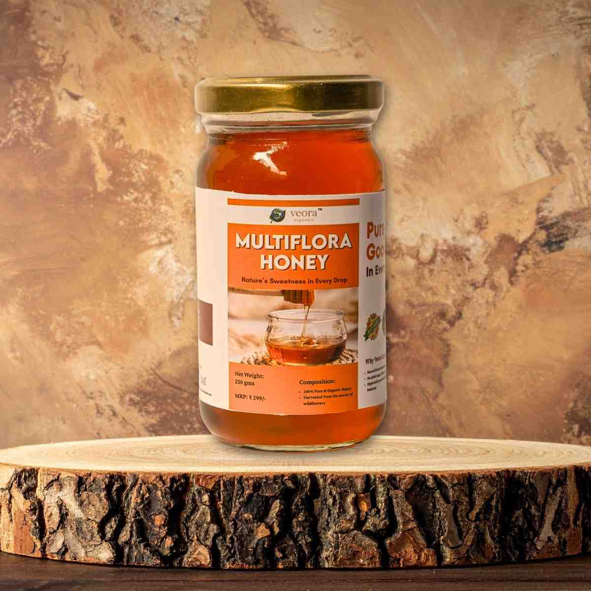 Jar of multiflora honey on a wooden surface with a textured brown background