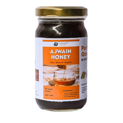 Jar of Ajwain honey with a gold lid on a white background