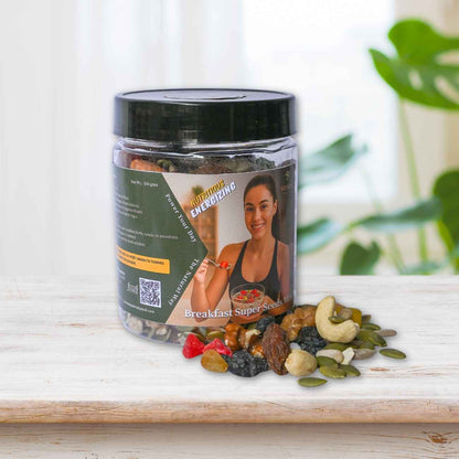Jar of 'Breakfast Super' mix with a woman on the label, surrounded by various nuts and seeds on a wooden surface.