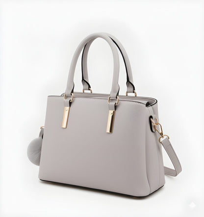 Gray handbag with gold accents on a white background