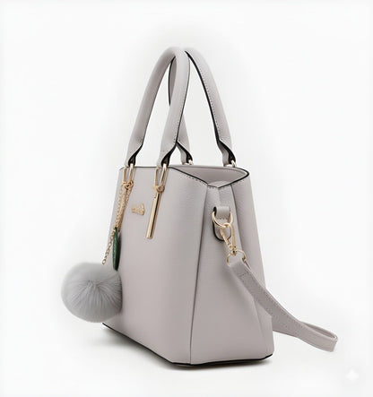 Light gray handbag with a decorative 