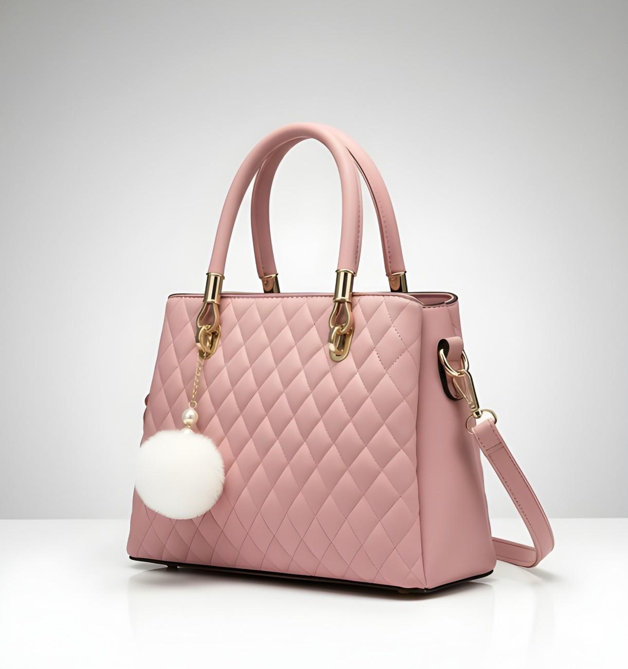 Pink quilted handbag with gold accents on a light gray background