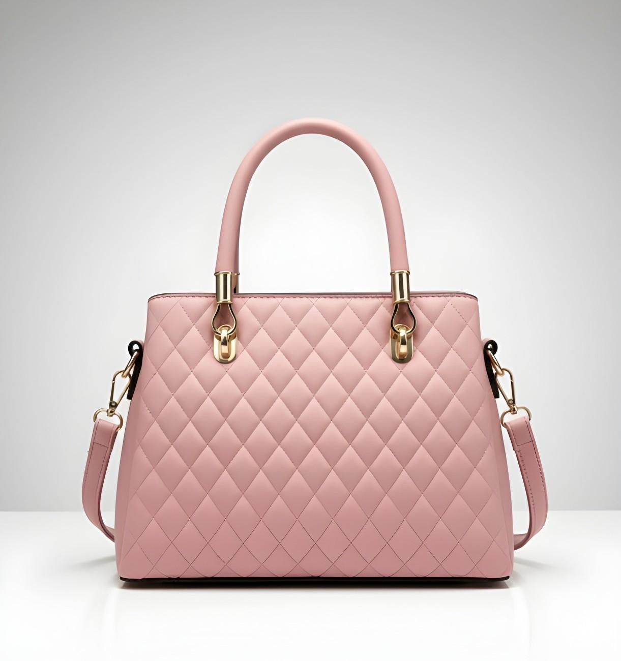 Pink quilted handbag with gold accents on a light gray background