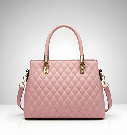 Pink quilted handbag with gold accents on a light gray background