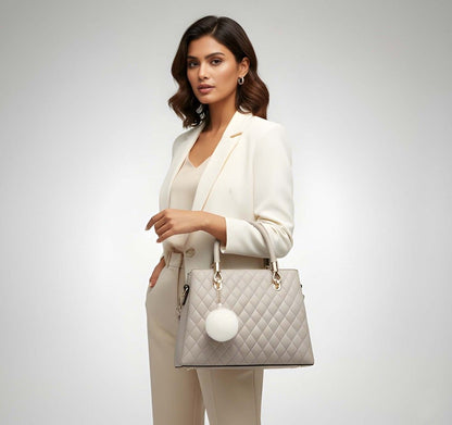 Woman holding a beige quilted handbag with a white background
