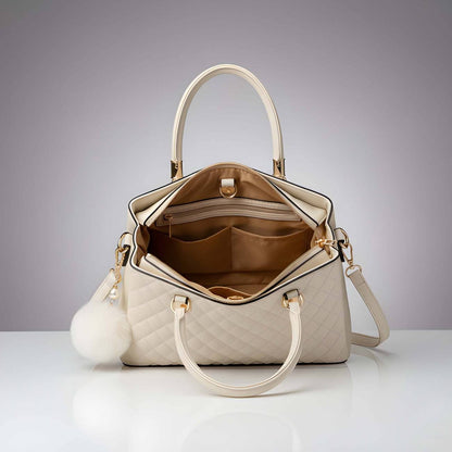 Beige handbag with gold accents on a light gray background