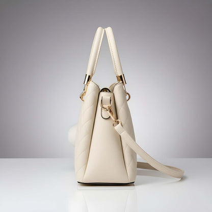 Beige handbag with gold accents on a gray background