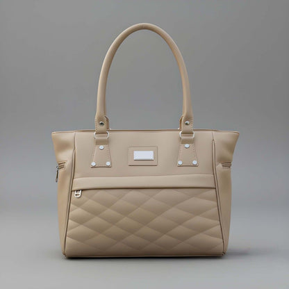Beige quilted handbag on a gray background