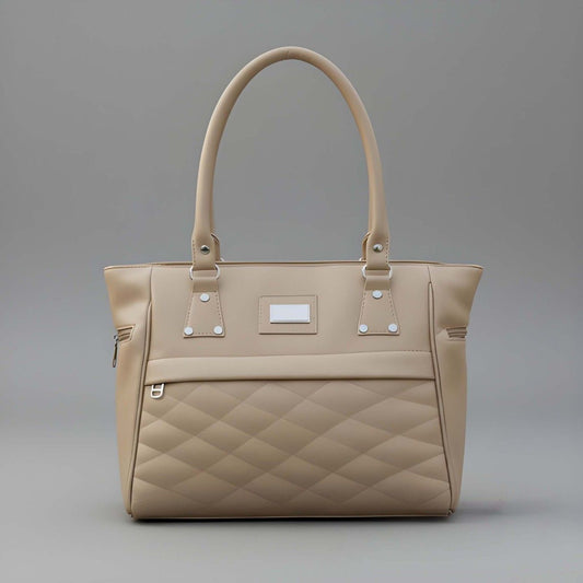 Beige quilted handbag on a gray background
