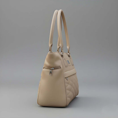 Beige handbag with quilted design on a gray background