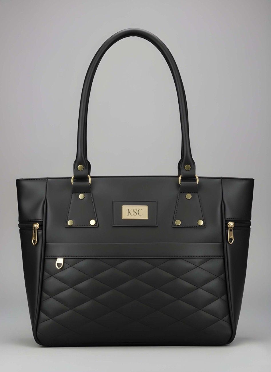 Black quilted handbag with gold accents on a gray background