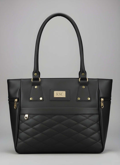 Black quilted handbag with gold accents on a gray background
