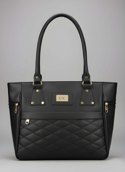Black quilted handbag with gold accents on a gray background