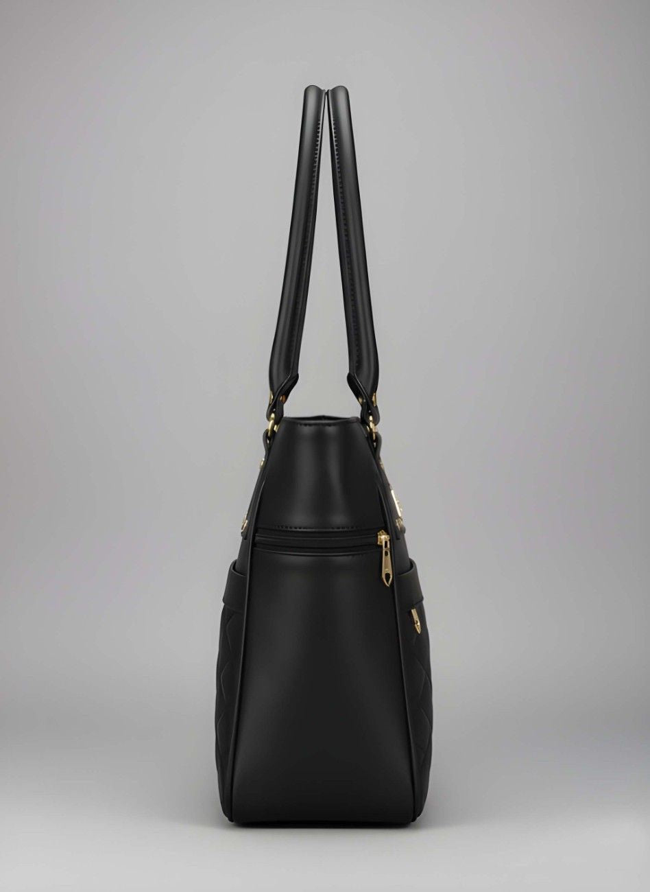 Black handbag with gold accents on a gray background