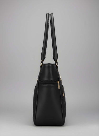 Black handbag with gold accents on a gray background