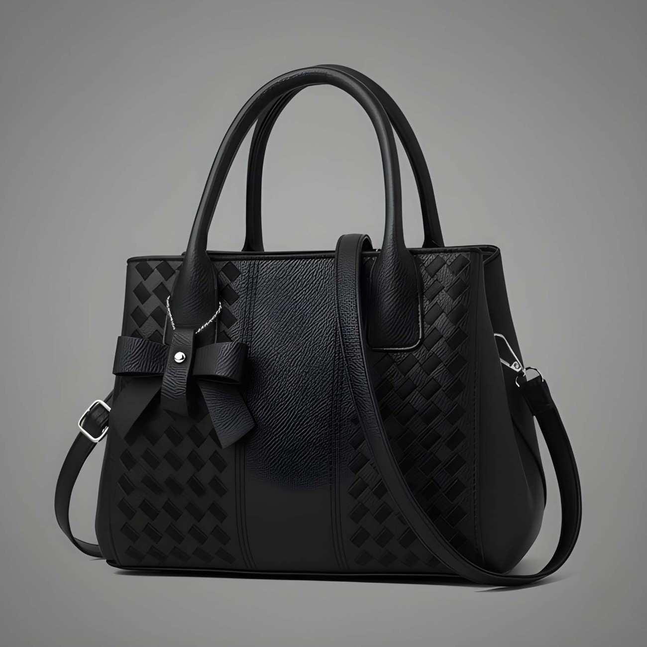 Black handbag with a textured pattern on a gray background