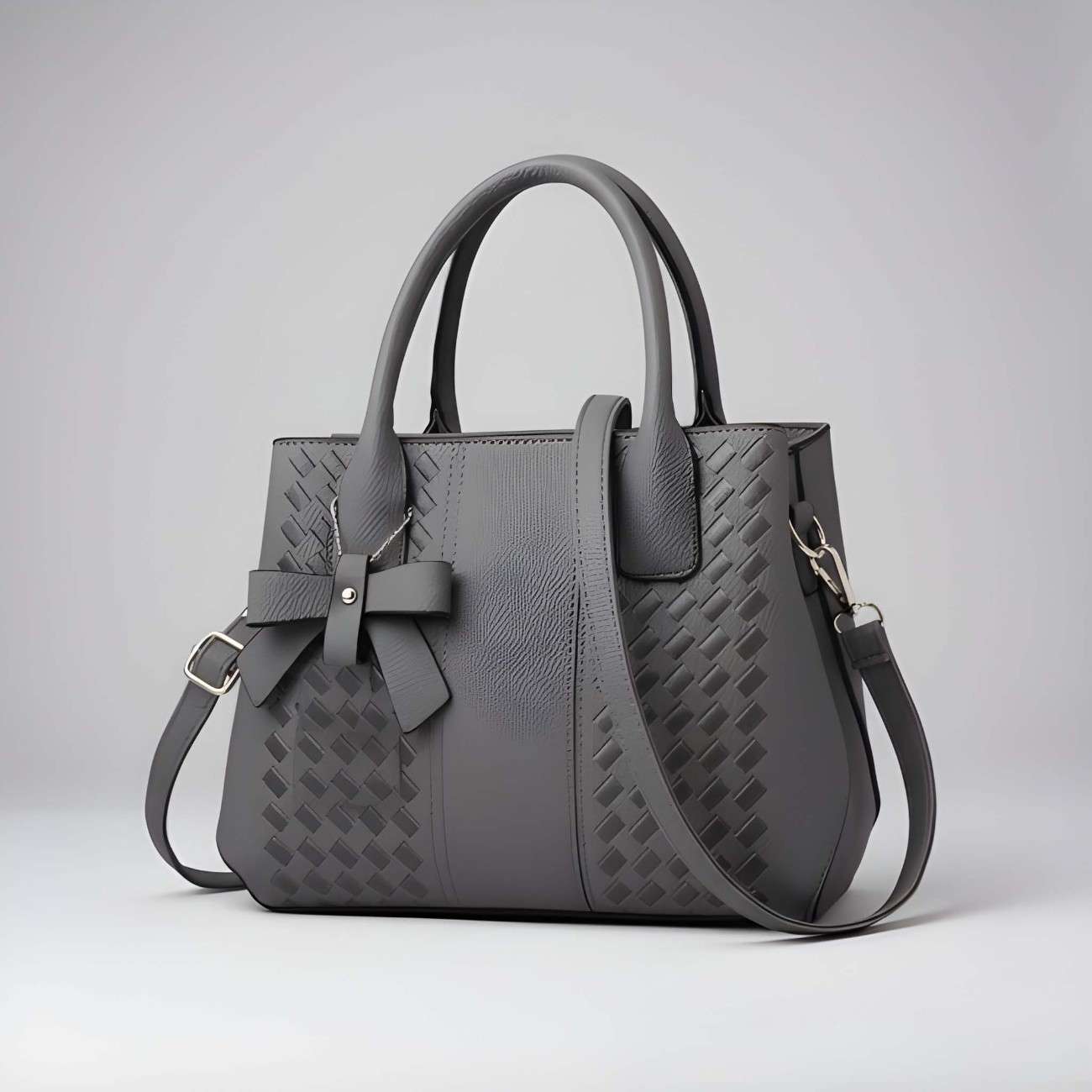Gray handbag with a bow detail on a light gray background