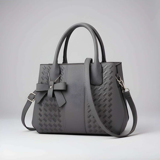 Gray handbag with a bow detail on a light gray background